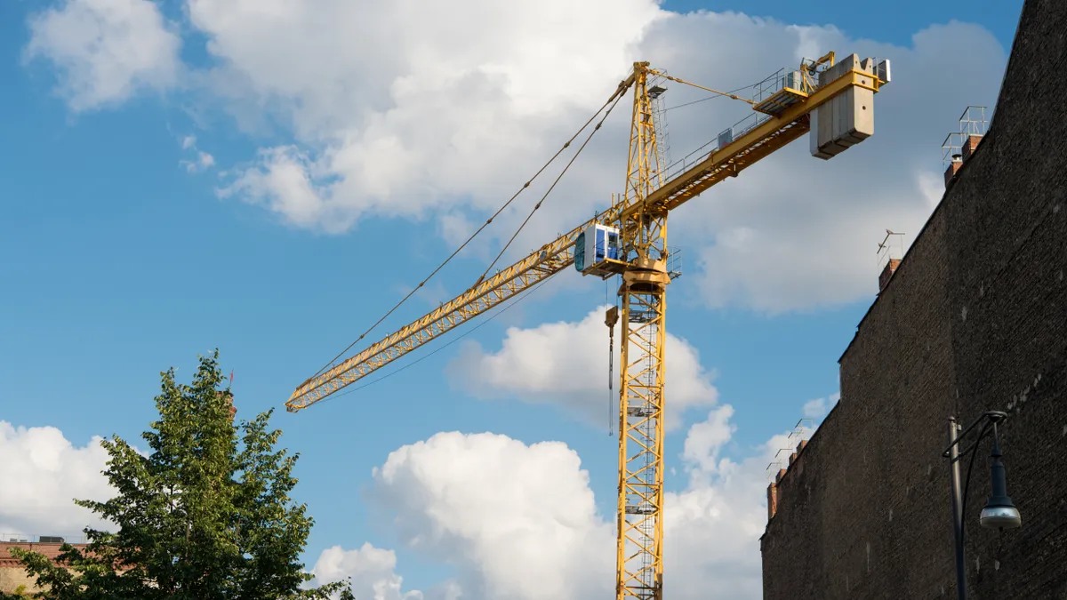 Picture of construction crane on cloudy sky.