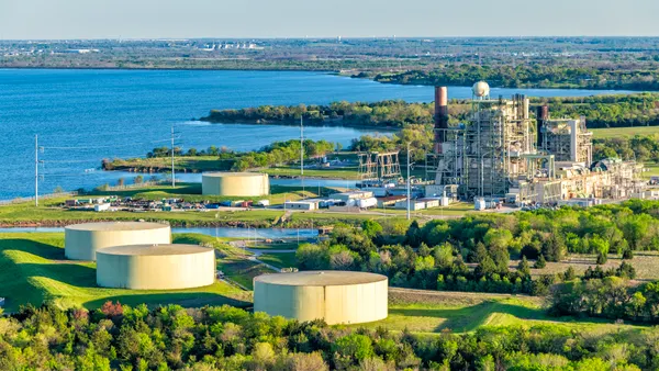 An aerial photo shows a natural gas power plant on the shores of a lake.