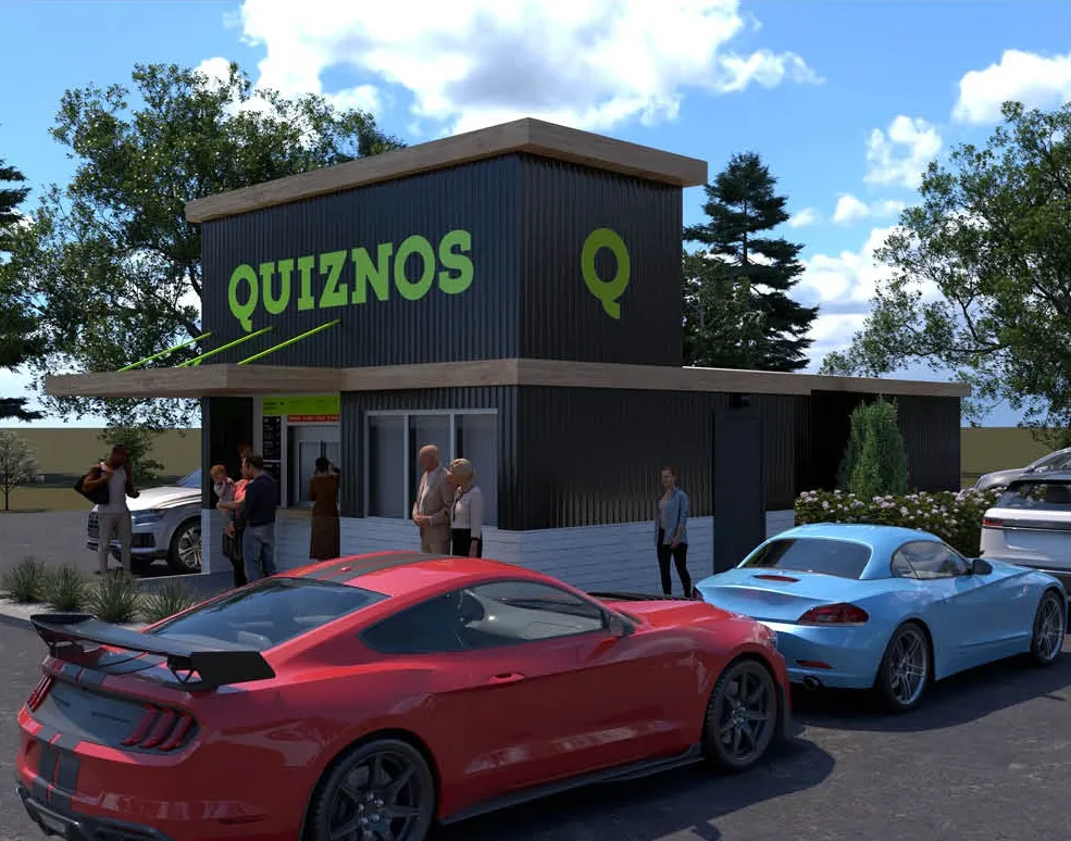 An image of a small gray building with green Quiznos wording on the side.