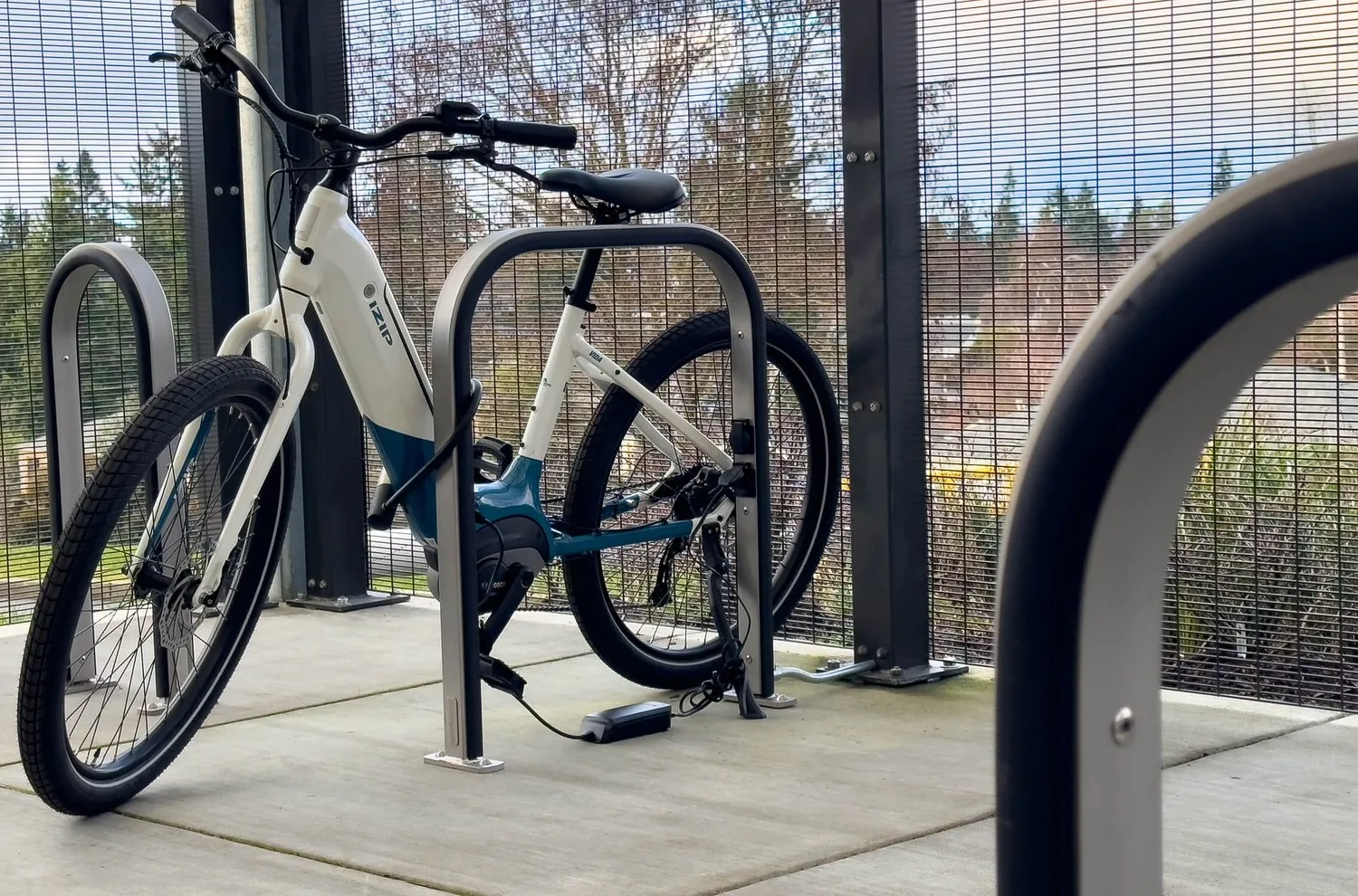 A bike rack with a bike tied to it.