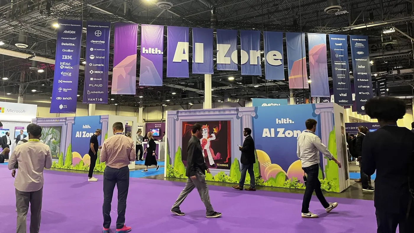 People walking past the AI Zone at HLTH 2025.
