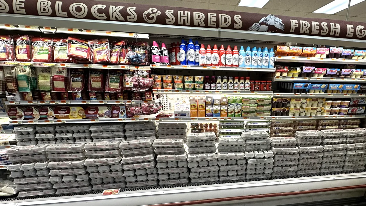 Cartons of eggs in a refrigerated case in a supermarket