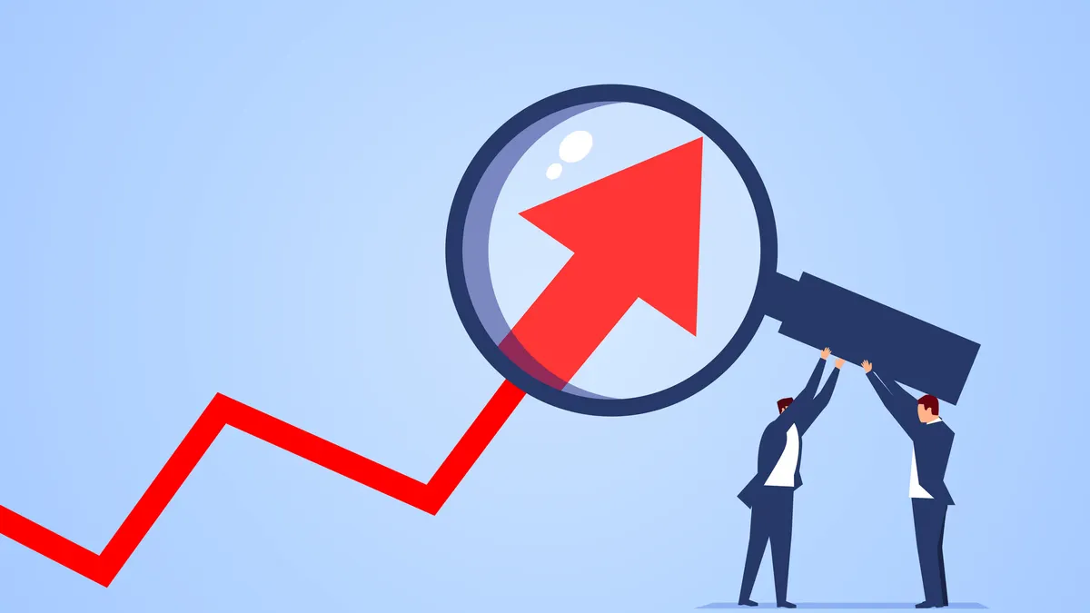 Two businessmen use magnifying glass to magnify arrows