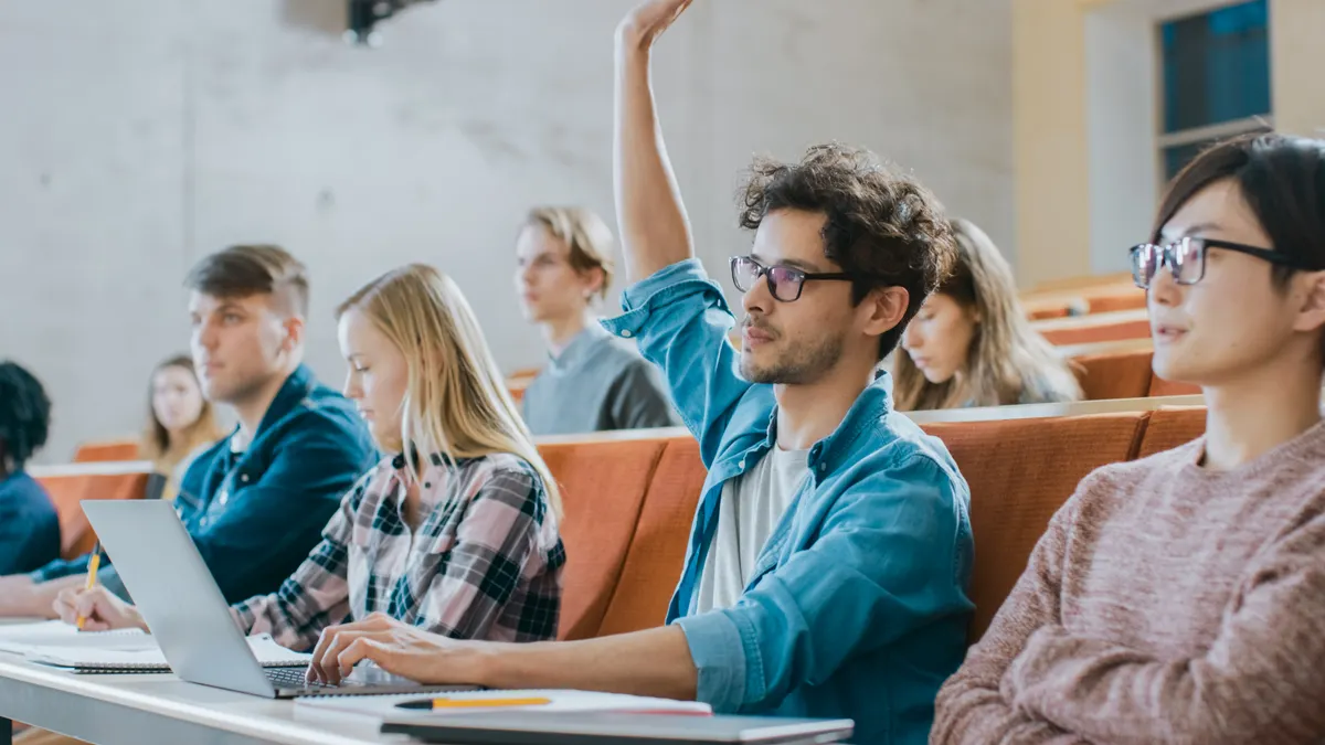 Student raising hand in class