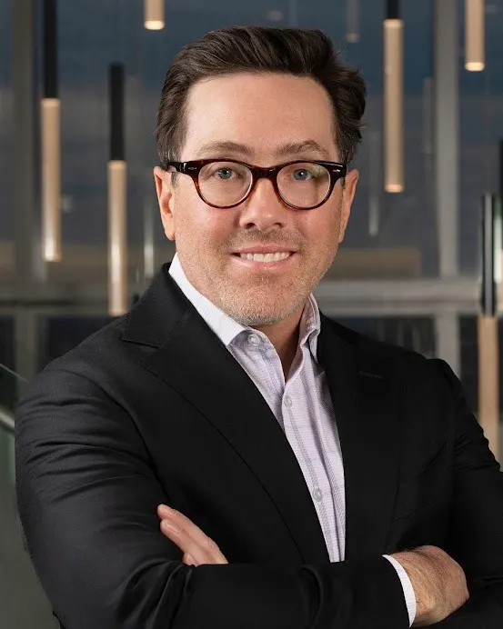 Headshot of a man in a suit.