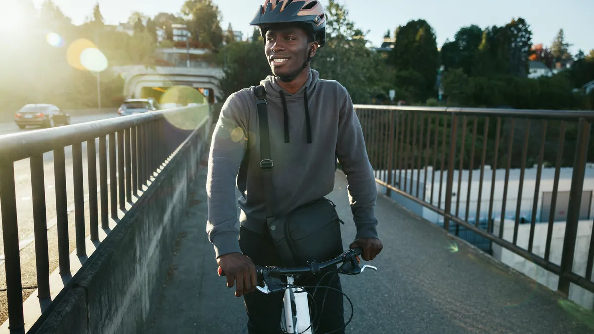 An adult man enjoys a bicycle ride on a sunny autumn day in Seattle.