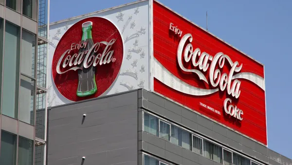 A neon Coca-Cola billboard sign.