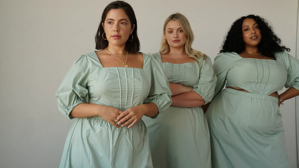 Three people in light sage green dresses