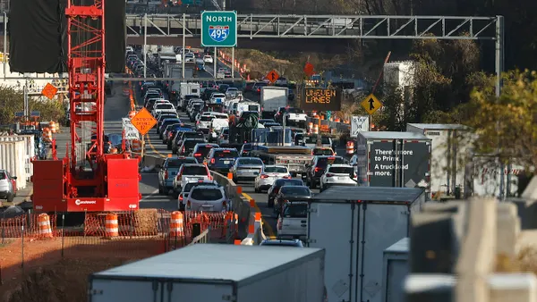 Vehicles travel past a construction site on Interstate 495