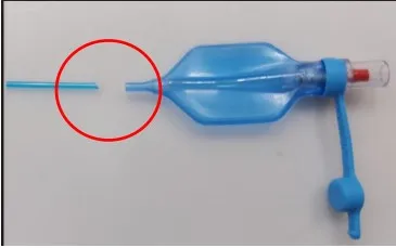 A red circle shows where a blue tube has detached from a blue balloon.