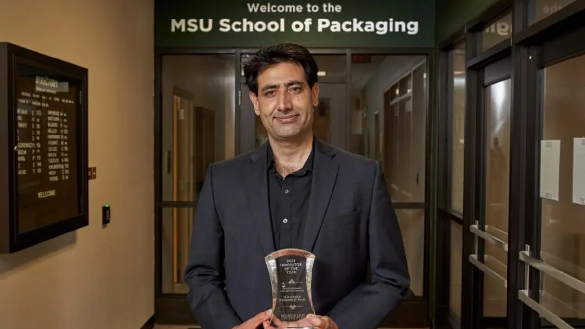Muhammad Rabnawaz stands under MSU School of Packaging sign