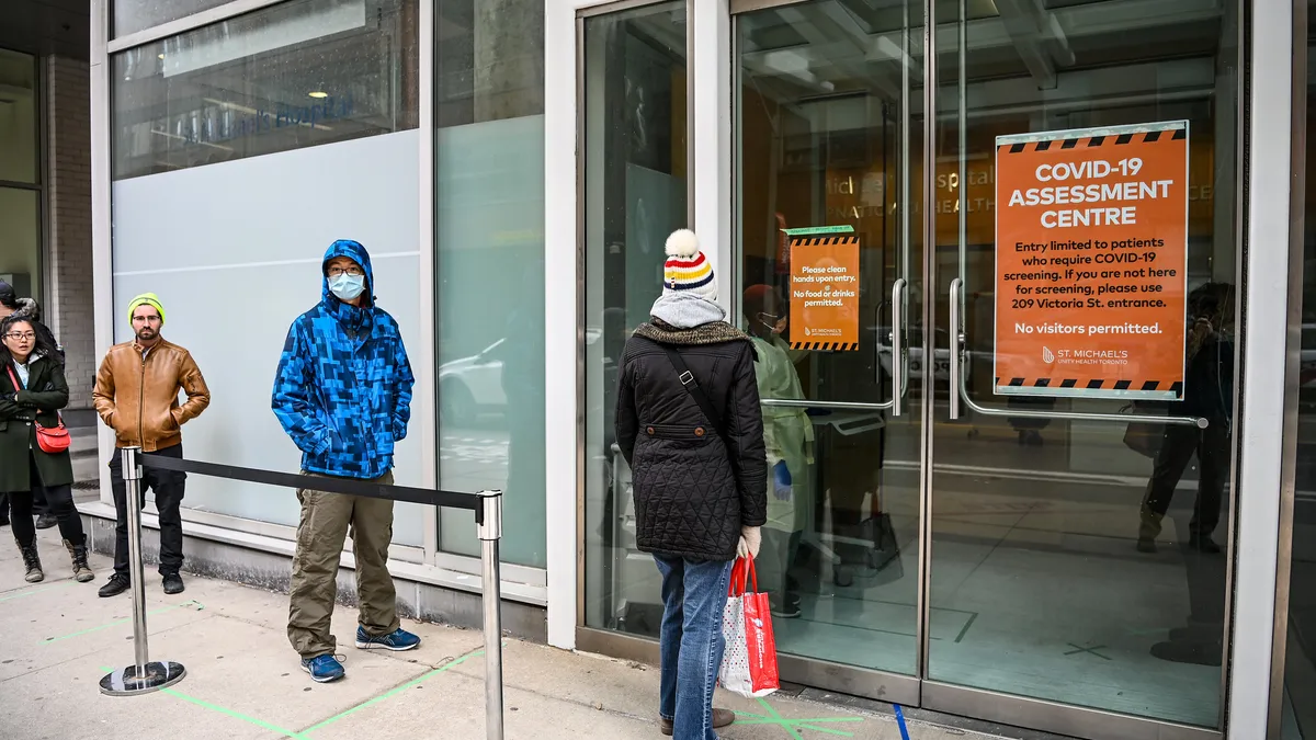 People line up to be assessed for COVID-19 at St. Michael's Hospital in Toronto. Taken on March 17, 2020