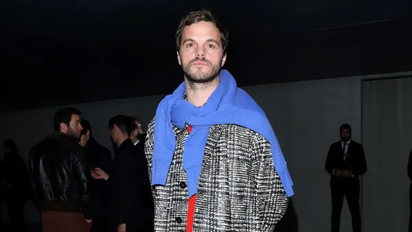 Matthieu Blazy wears Prada at a fashion show in Milan.