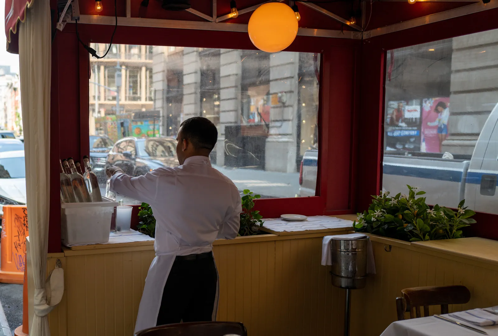 New York City waiter prepares dining room