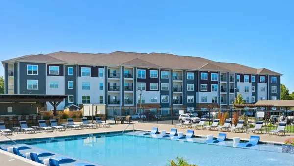 Garden-apartment property with a pool in the foreground.