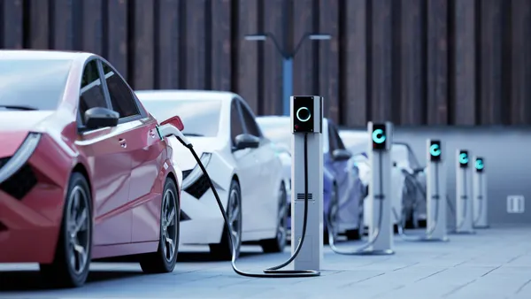 A row of electric vehicles charging on the street.
