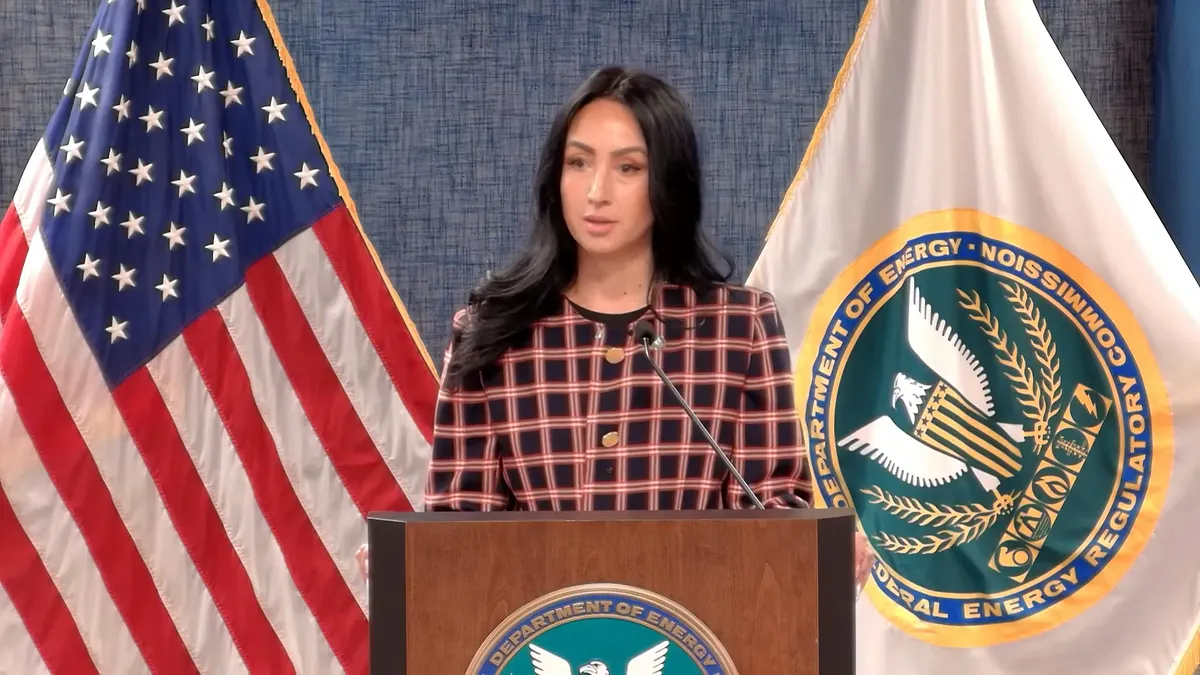 A woman speaks from a podium.