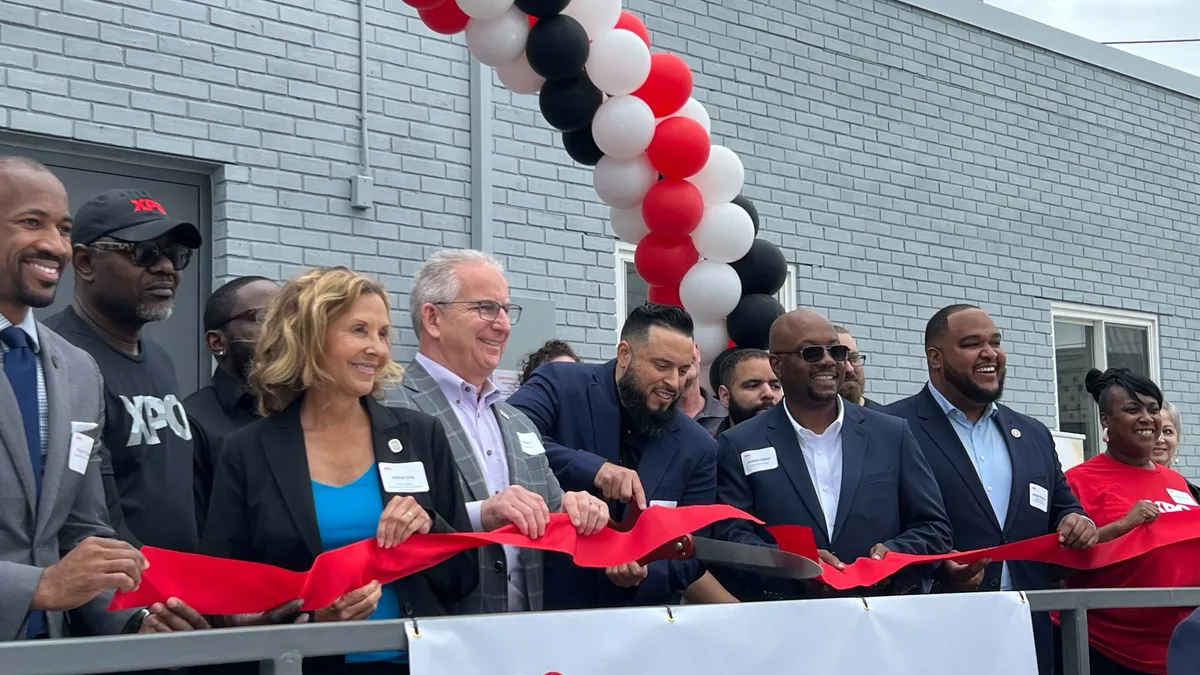 XPO Service Center Manager Steve Zapata cuts a ribbon at the new Landover, Maryland terminal alongside employees and dignitaries.