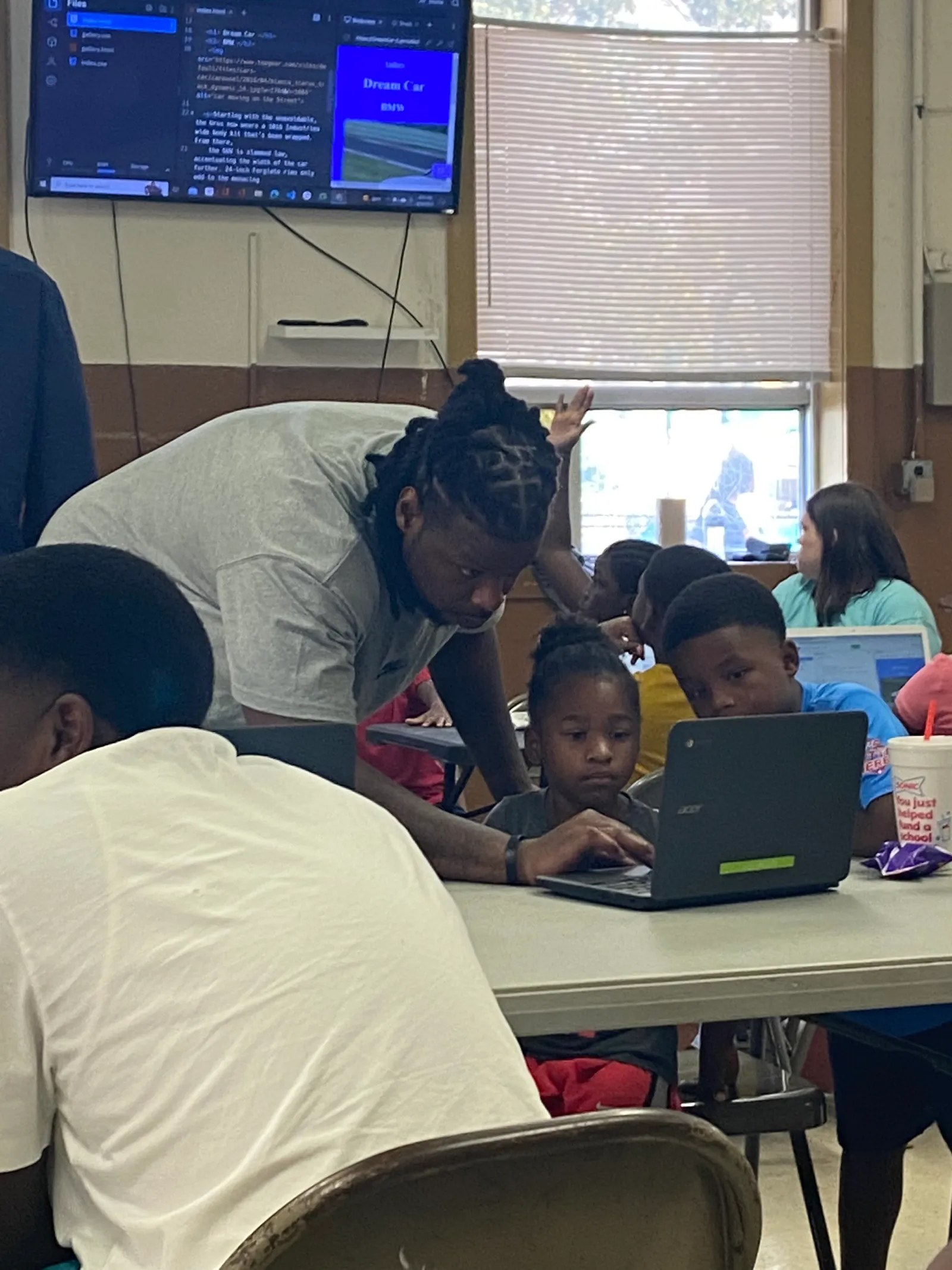 A Persevere graduate teaches coding to children