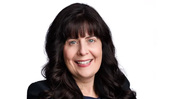 An image of a person wearing a black suit jacket