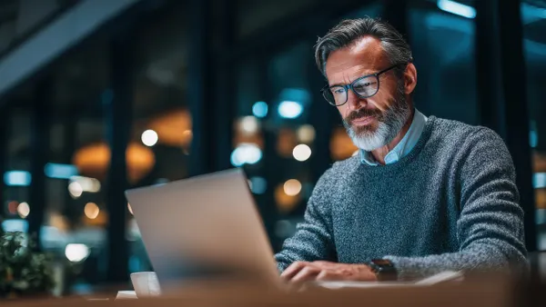 person sitting at laptop