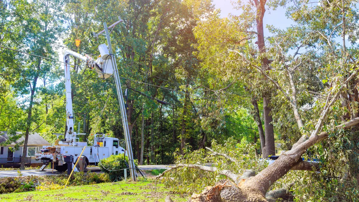 A utility crew works on a power line to repair storm damage.