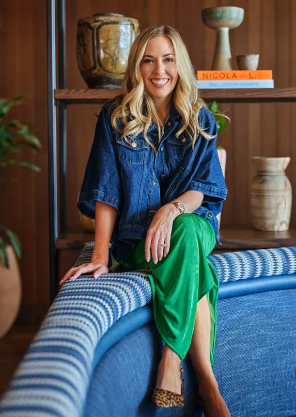 Seated blond woman in professional attire.