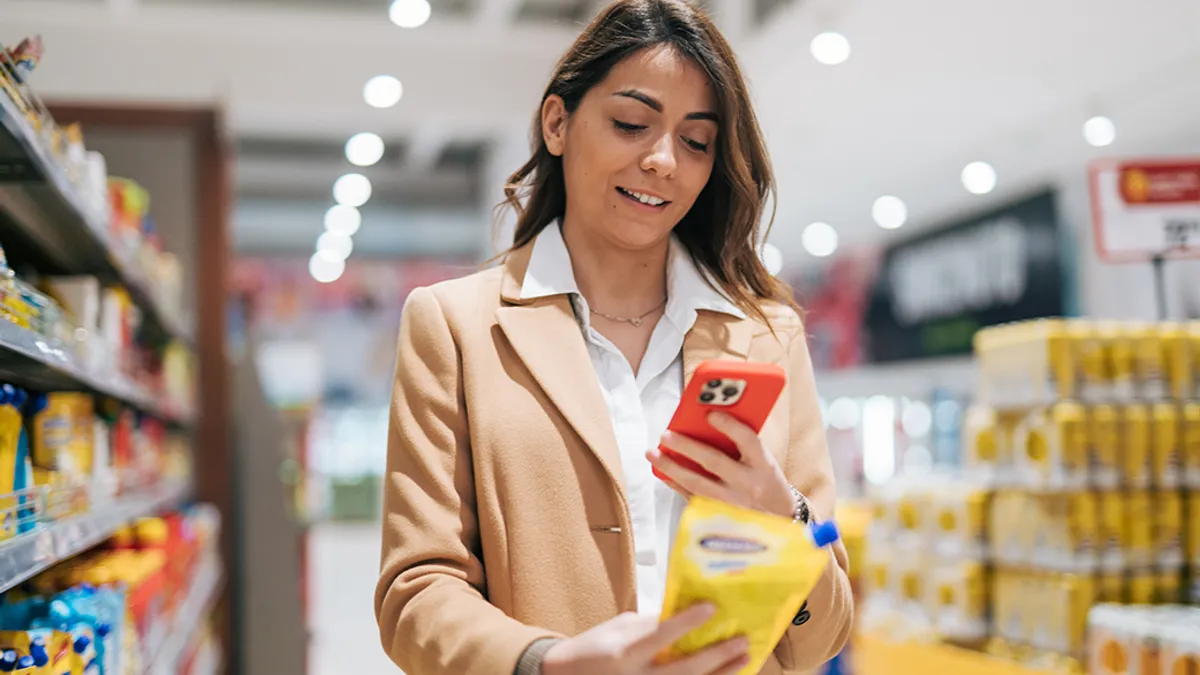 Woman taking a picture of a product at the grocery store