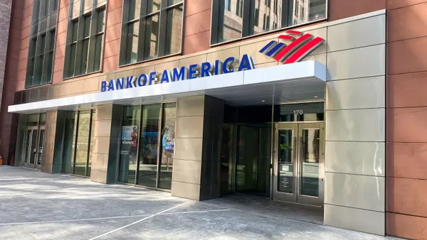 A paneled building facade with "Bank of America" signage and logo is shown above an entrance with glass doors.