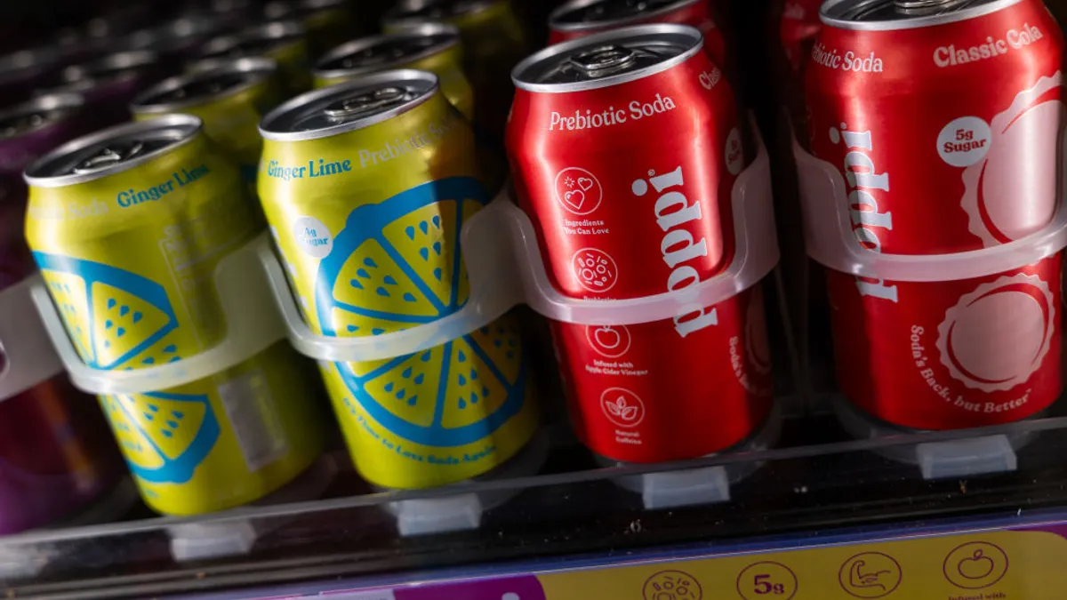 Cans of Poppi soda are displayed on a shelf
