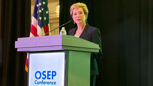 A person stands at a podium. A sign on the podium reads OSEP conference 2026