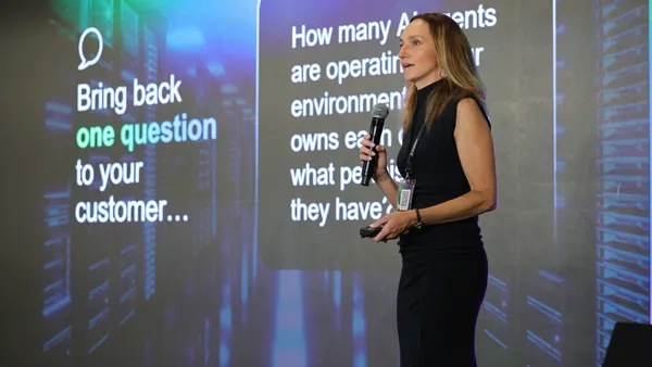 woman speaking in front of a screen that says Exabeam Partner Program