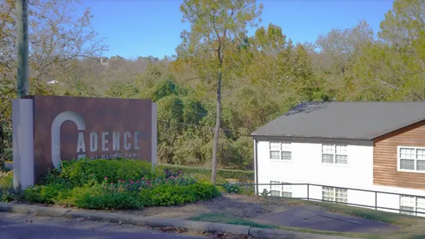 Exterior of apartment with Cadence at Bluff Park sign
