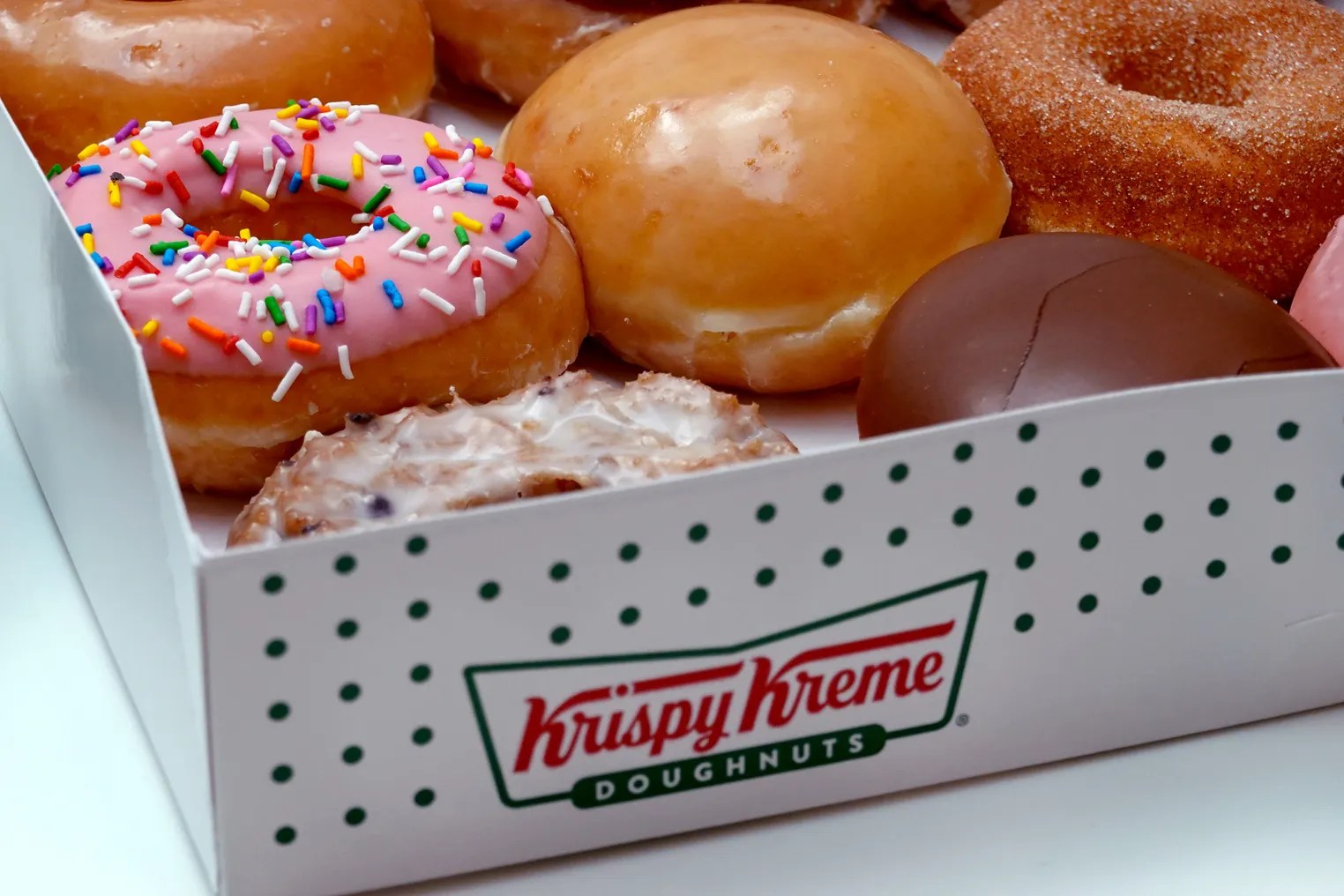 Krispy Kreme doughnuts are displayed in a box.