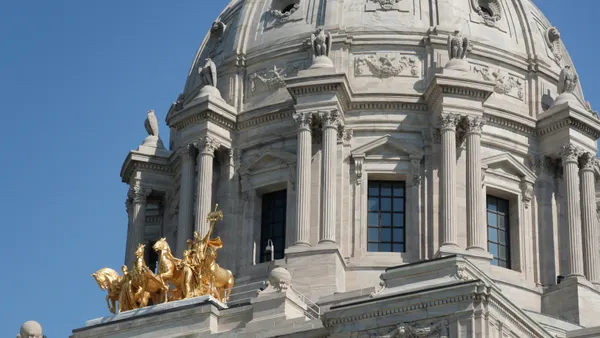 A close up of the white dome on a government building.