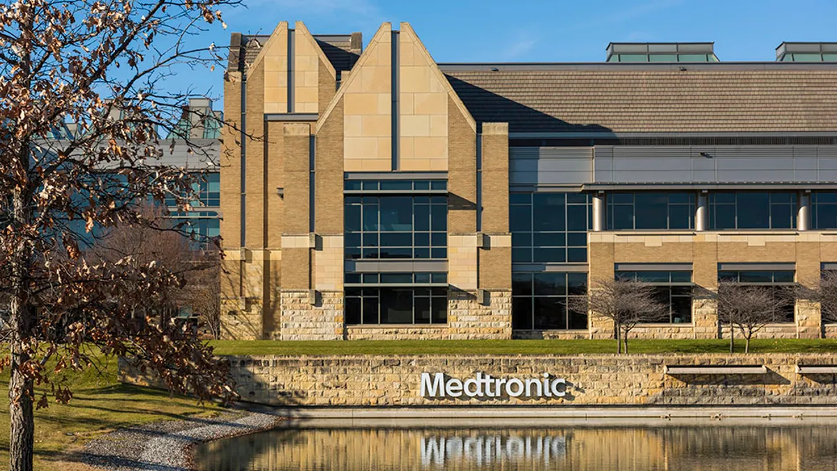 The exterior of Medtronic's Minnesota operational headquarters is shown along with its reflection in a pool of water.