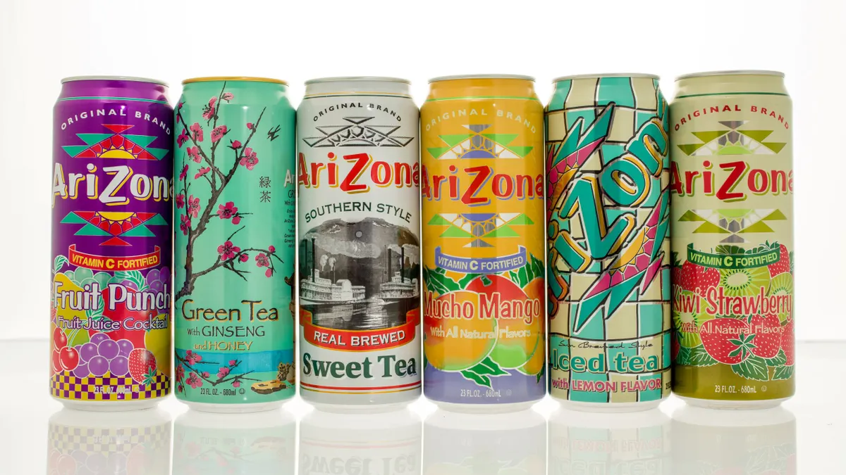Six cans of Arizona tea are lined up next to each other.