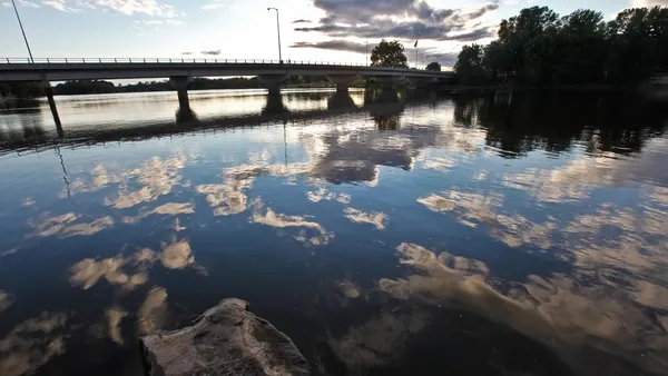 A bridge over a waterway in Wisconsin Rapids, Wisconsin, at sunset.