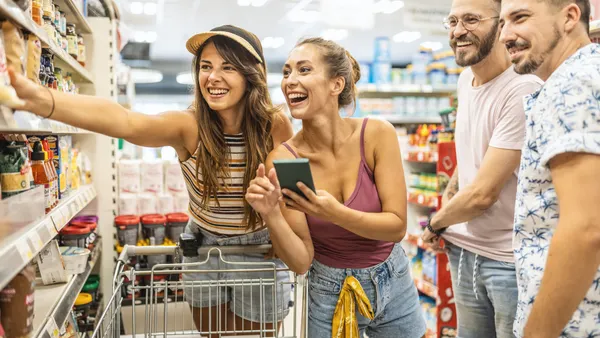 Group of friends shopping together in a supermarket