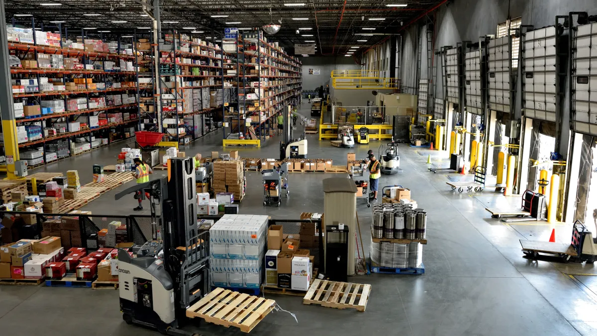 Workers complete various tasks inside an alcohol warehouse.