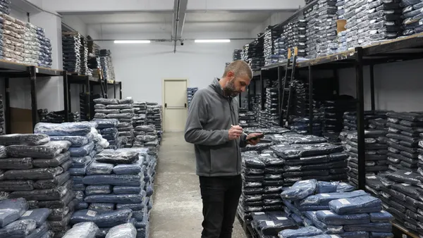 A man seen doing a quality check in a textile factory.