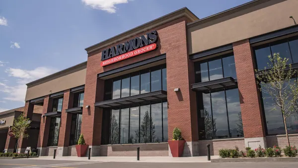 A brick building with a sign that says "Harmons Neighborhood Grocer" at the top.