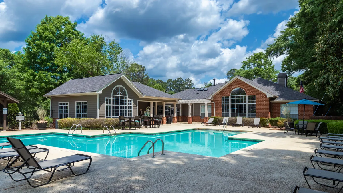 Apartment property with a pool in the foreground.