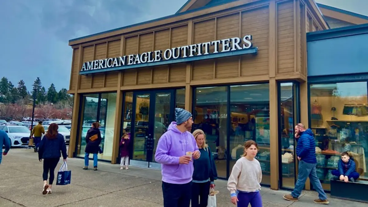 People walking past an American Eagle store.