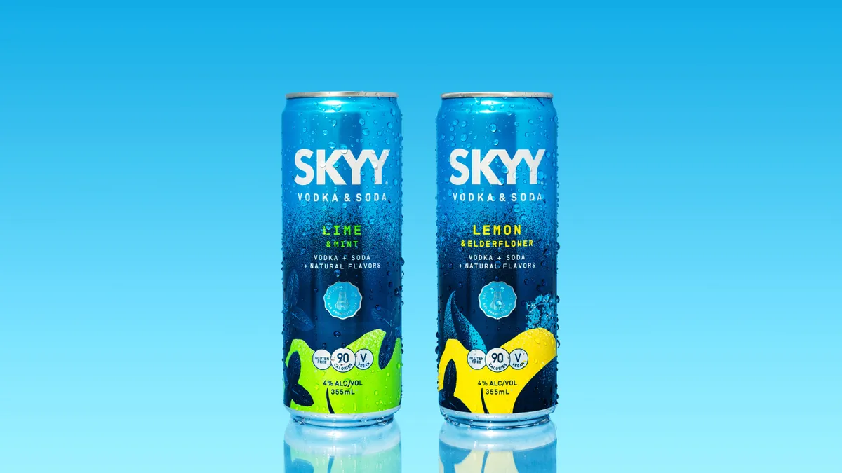 A photo of cans of Skyy Vodka & Soda against a blue background