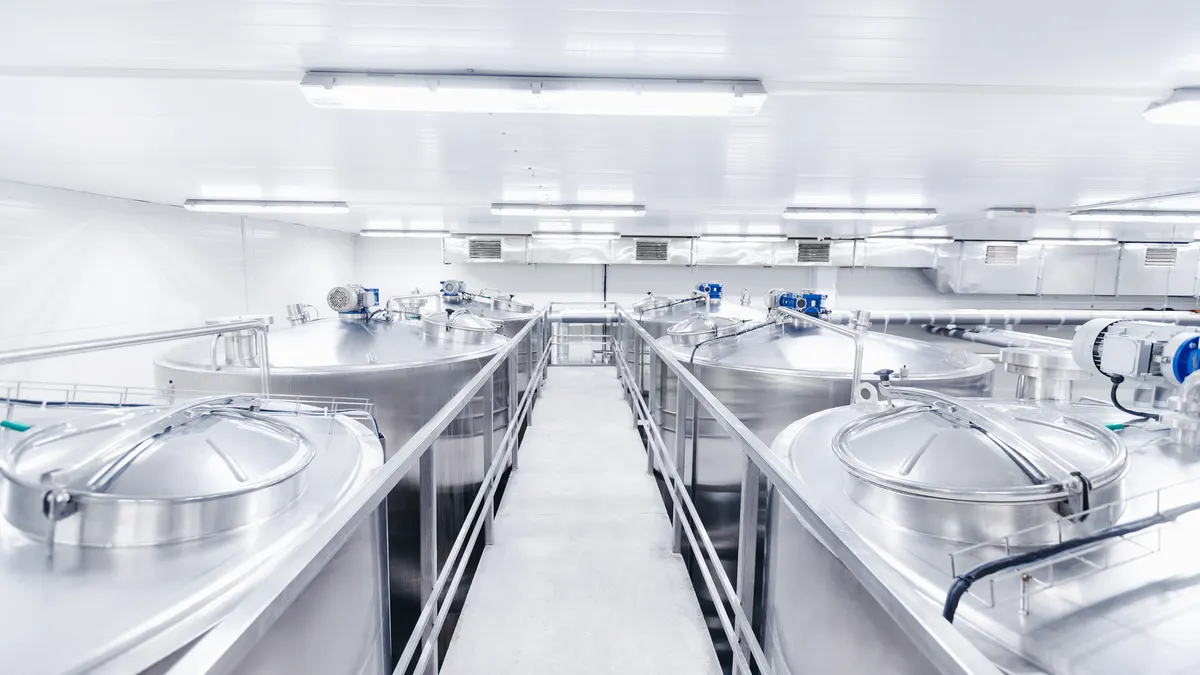 Equipment dairy plant, milk factory industry. Stainless steel storage and processing tanks.