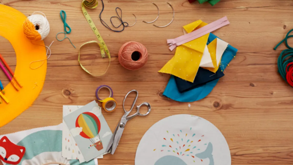 Various crafting supplies on a wood surface.