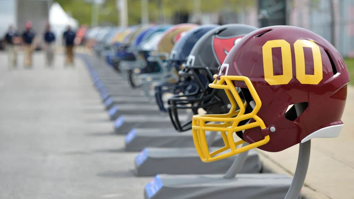 A row of oversized NFL helmets.