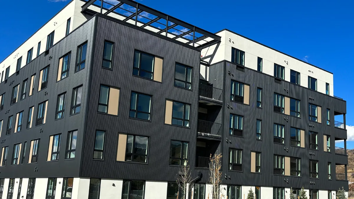 A five-story apartment building with a dark exterior.