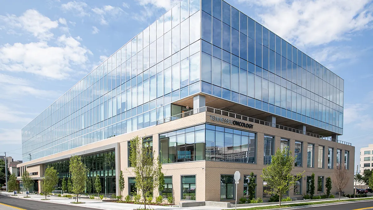 A photo shows a medical office building on a sunny city street.